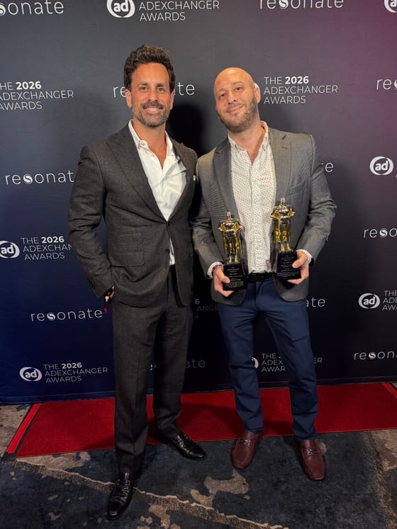 David Nyurenberg, right, holding both 2026 AdExchanger Awards trophies on the red carpet